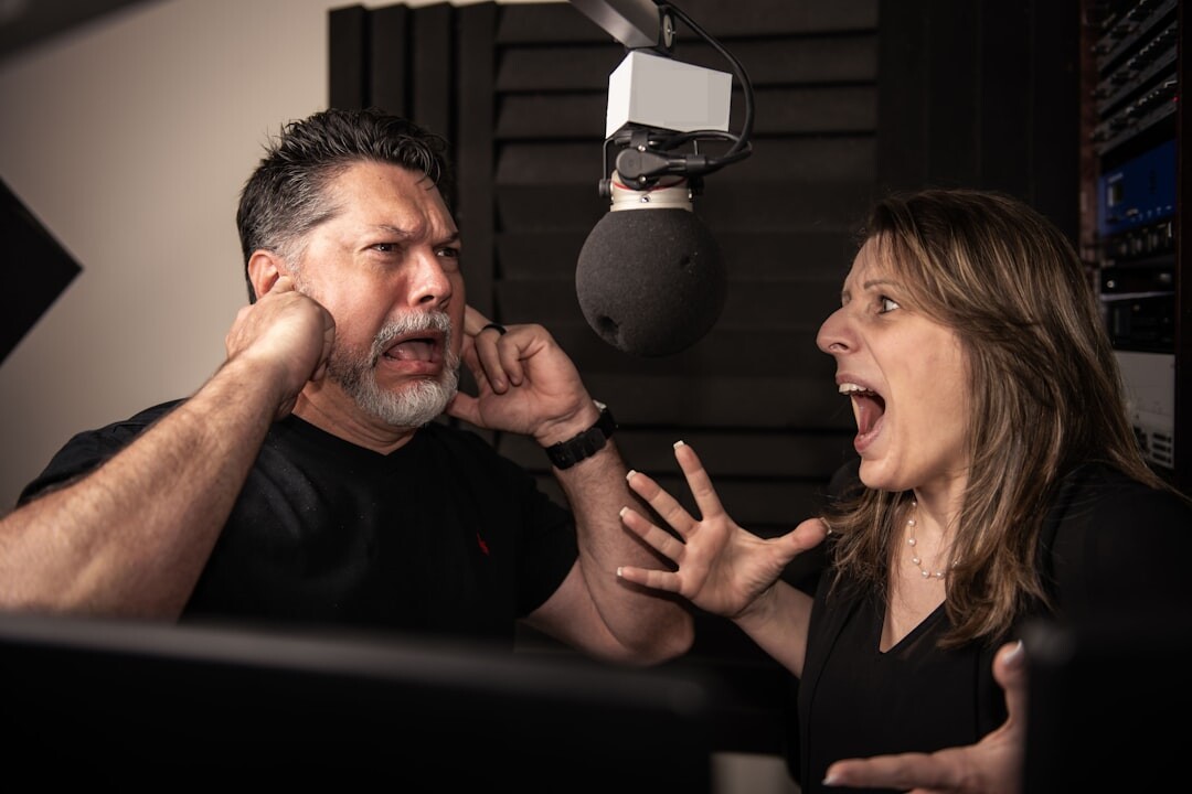 Two people recording a podcast interview with microphones