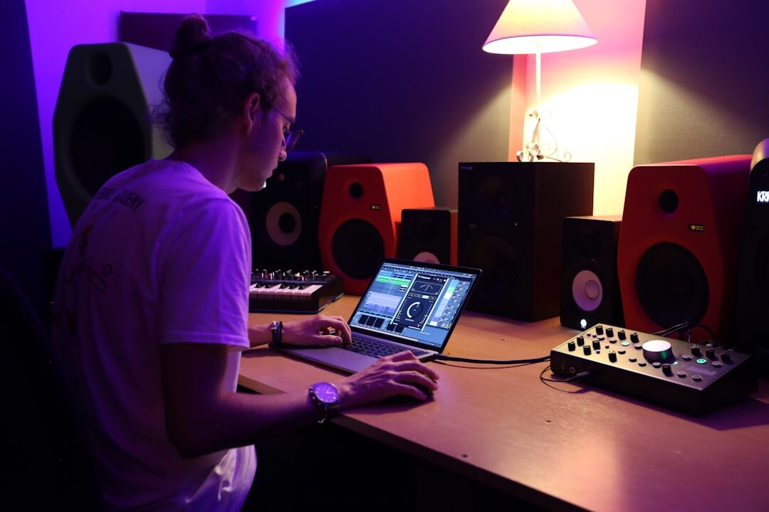 Audio engineer working at mixing console in recording studio